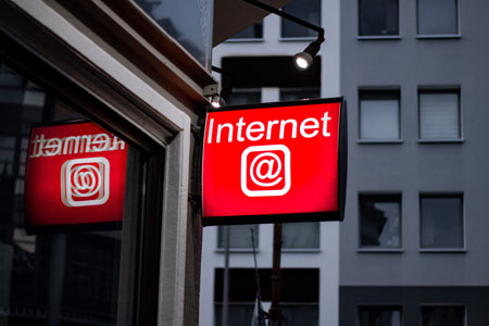A red Internet sign hangs on the side of a building.